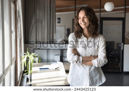 Similar – Foto Bild Positive Frau mit gewelltem Haar schaut in die Kamera