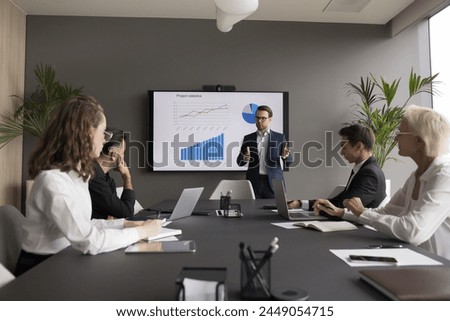 Similar – Image, Stock Photo Businesswoman discussing financial data with her colleague sitting at desk in office. Woman entrepreneur working with charts and tables on computer. Two people working together