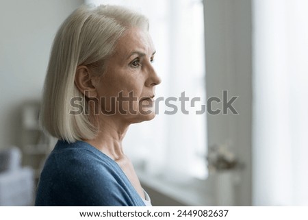 Similar – Image, Stock Photo Anxious elderly woman standing near window during pandemic