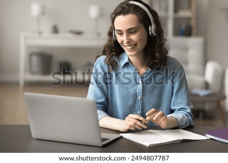 Similar – Image, Stock Photo Schoolgirls looking for audio books in school library. Students choosing books. Elementary education. Doing homework. Back to school