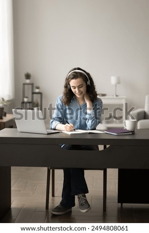 Similar – Image, Stock Photo Schoolgirls looking for audio books in school library. Students choosing books. Elementary education. Doing homework. Back to school