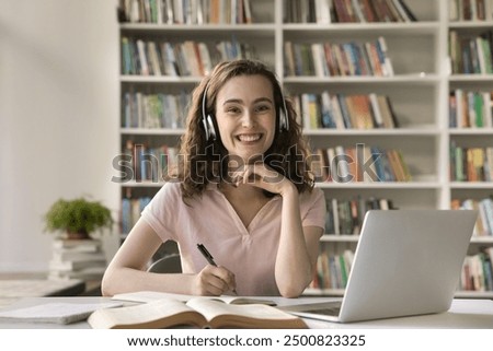 Similar – Image, Stock Photo Schoolgirls looking for audio books in school library. Students choosing books. Elementary education. Doing homework. Back to school