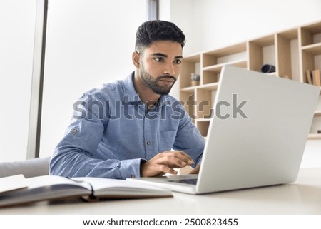 Similar – Image, Stock Photo Focused worker using laptop in office