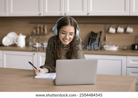 Similar – Image, Stock Photo Schoolgirls looking for audio books in school library. Students choosing books. Elementary education. Doing homework. Back to school