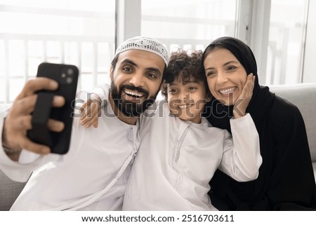 Similar – Image, Stock Photo Positive Arab woman having video call in park
