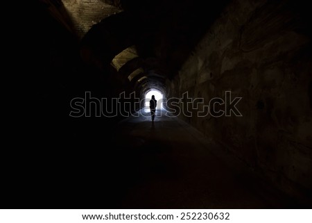 Person in dark tunnel, going towards the light.