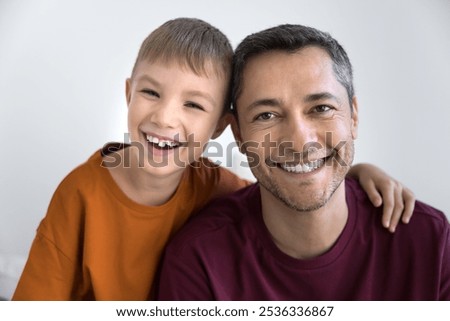 Similar – Foto Bild Vater mit zwei, kleinen Kindern in Badehose und roten T-Shirts, stehen am Meer und beobachten eine Welle des Wassers, welche in ihre Sandburg am Strand spült. Die Familie hält Schaufel und Werkzeug in den Händen und staunen neugierig über das Wasserpiel.