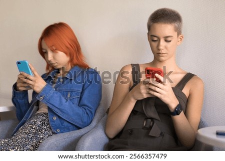 Similar – Image, Stock Photo Two schoolgirls spending time in school library. Primary school students learning from books. Children having fun in school club. Doing homework