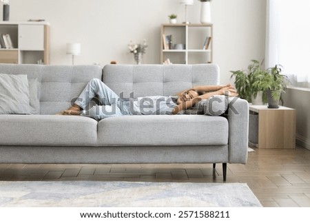 Similar – Image, Stock Photo Peaceful child daydreaming while lying on horse