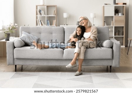 Similar – Image, Stock Photo Two schoolgirls spending time in school library. Primary school students learning from books. Children having fun in school club. Doing homework