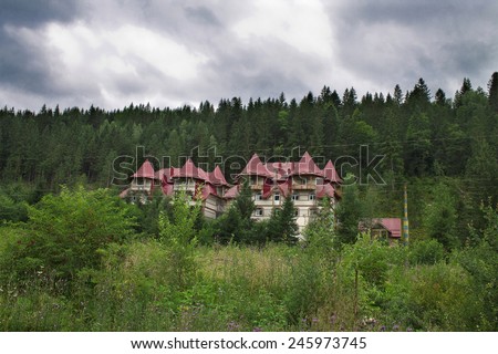 Several houses in the forest near the foot of the mountain