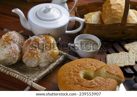 Farm table with the breakfast sweet bread italian bread coffe and cracker