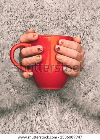 Similar – Image, Stock Photo Hand holding red cup with steaming drink against the light