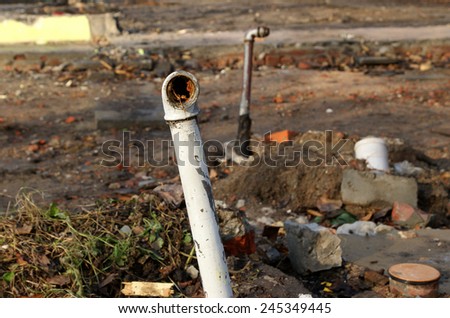 Old, dirty and rusty water pipes after building demolition