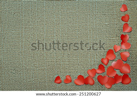 Valentine\'s day card with red hearts on fabric sack texture background