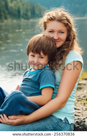 happy mother and son near the river