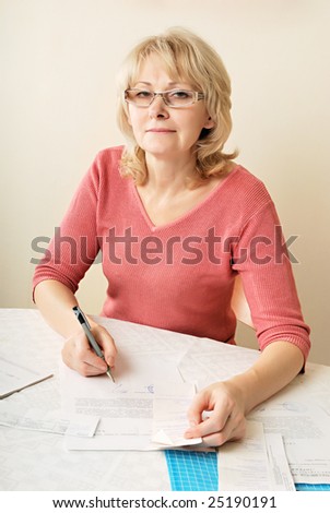 Adult blond woman signing documents