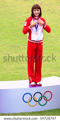 SINGAPORE - AUG. 21:Ekaterina Bleskina stands on the medal podium after accepting the gold medal on Aug. 21, 2010 in Singapore. Inaugural Youth Olympic Games, 100m hurdles event.