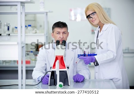 man and woman in lab researching