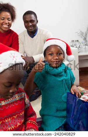 Girl opening her gift, finger up