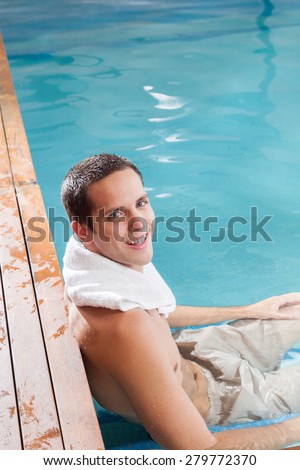 Happy guy relax inside the pool