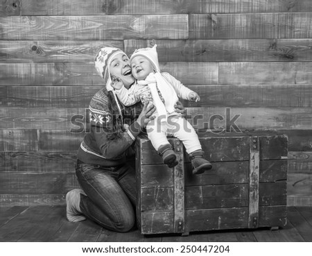 black and white, Mom and daughter smiling in multicolored studio interior