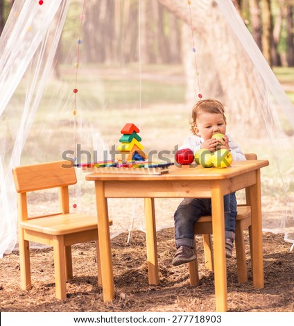 little girl eating an apple, nature, musical toys