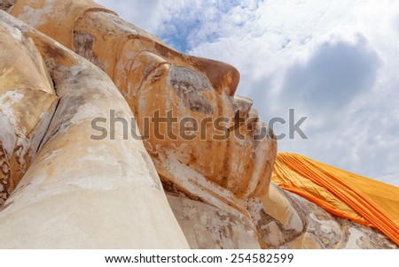 close up big buddha lay down outdoor  in blue sky day
