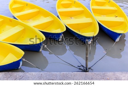 yellow fiber boat tied together in the pool of park