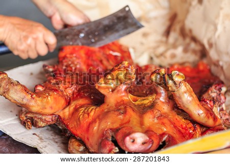 grilled pig on plate cut by chef