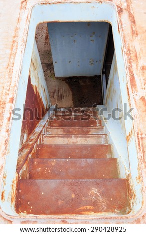 rusty iron stairs step down in the ship in close up