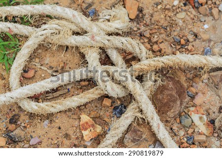 rope tied on sand beach floor background