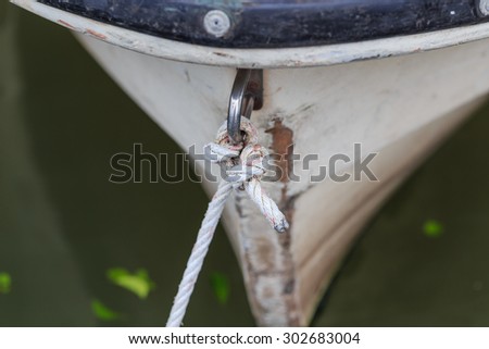 Rope tied the bow of a Hand crafted wooden rowboat
