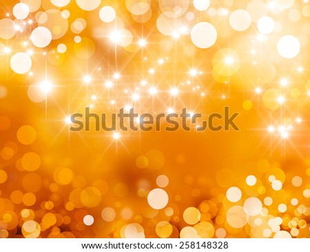 Festive sparkling lights. Shiny gold background in starlight and sparkles