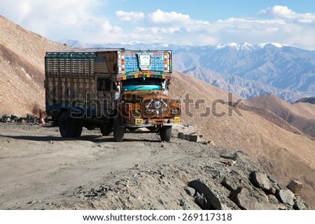 INDIA, LADAKH, CIRCA SEPTEMBER 2013 - Colorful truck brand TATA in Indian Himalayas on himalayan high altitude road near Khardung La pass, highest road pass on world - Ladakh, Jammu and Kashmir, India