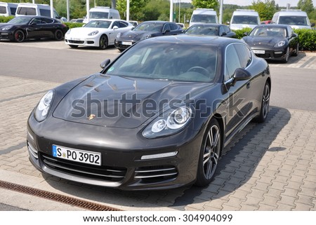 PRAGUE, THE CZECH REPUBLIC, 02.08.2015 - New Porsche Panamera parking in front of car store Porsche Prosek Prague