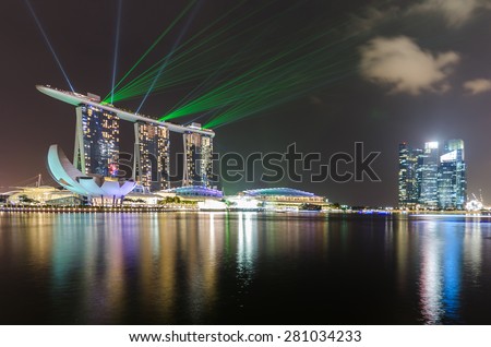 SINGAPORE-OCT 06 , 2014 : Singapore skyline of marina bay in Singapore at night and laser show at marina bay sands hotel