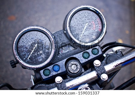 Motorcycle speed clock covered in rain water