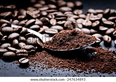 Coffee seeds on black surface closeup