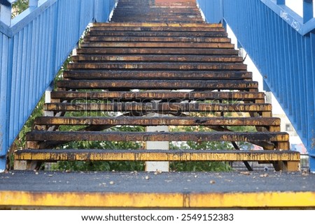 Similar – Foto Bild alte rostige Treppe mit Schäden gegen den blauen Himmel und die Wolken