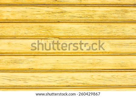 Yellow painted wooden desks texture.