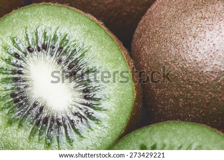 Kiwi fruit cut in studio on wood.