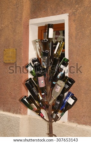 HALL IN TIROL, AUSTRIA - AUGUST 15: A decorative tree made from empty wine bottles on Schlossergasse street on August 15, 2015 in Hall in Tirol.