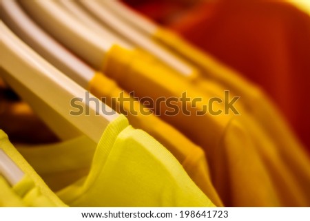 Preview yellow blouse on a hanger in the closet hanging