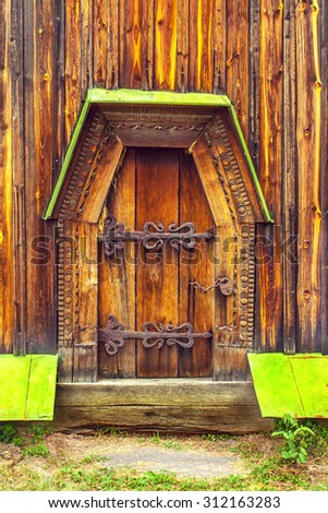 a antique wooden doors on forged curtains locked