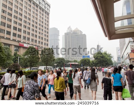 CHENGDU, CHINA - MAY 27, 2012: Unidentified people on the street of Chengdu, China. With more than 14 million people, Chengdu is the fourth most populous city in mainland China.