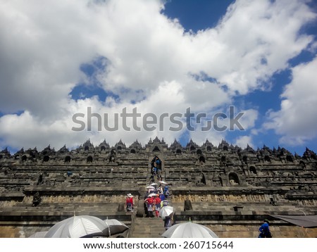 MAGELANG, INDONESIA - SEPTEMBER 14, 2013: Unidentified people at Borobudur temple at Central Java in Indonesia. It is  a 9th-century Mahayana Buddhist Temple in Magelang, Central Java.