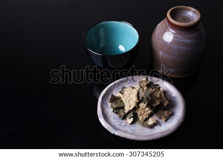 Traditional Japanese cups and bowl on black background