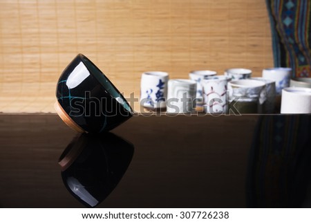 Reflection of traditional Japanese ceramic product on black glass