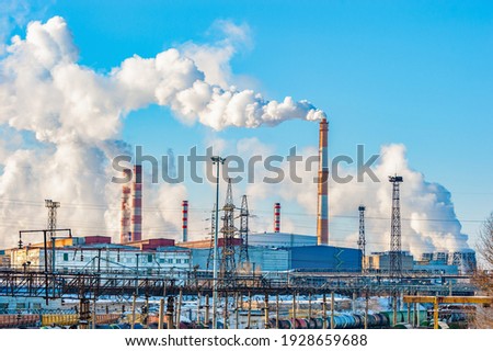 The pipes of the metallurgical plant, from which dirty smoke rises into the clear sky. Air pollution! Exhaust gases, depletion of the ozone layer,the greenhouse effect. An environmental disaster.